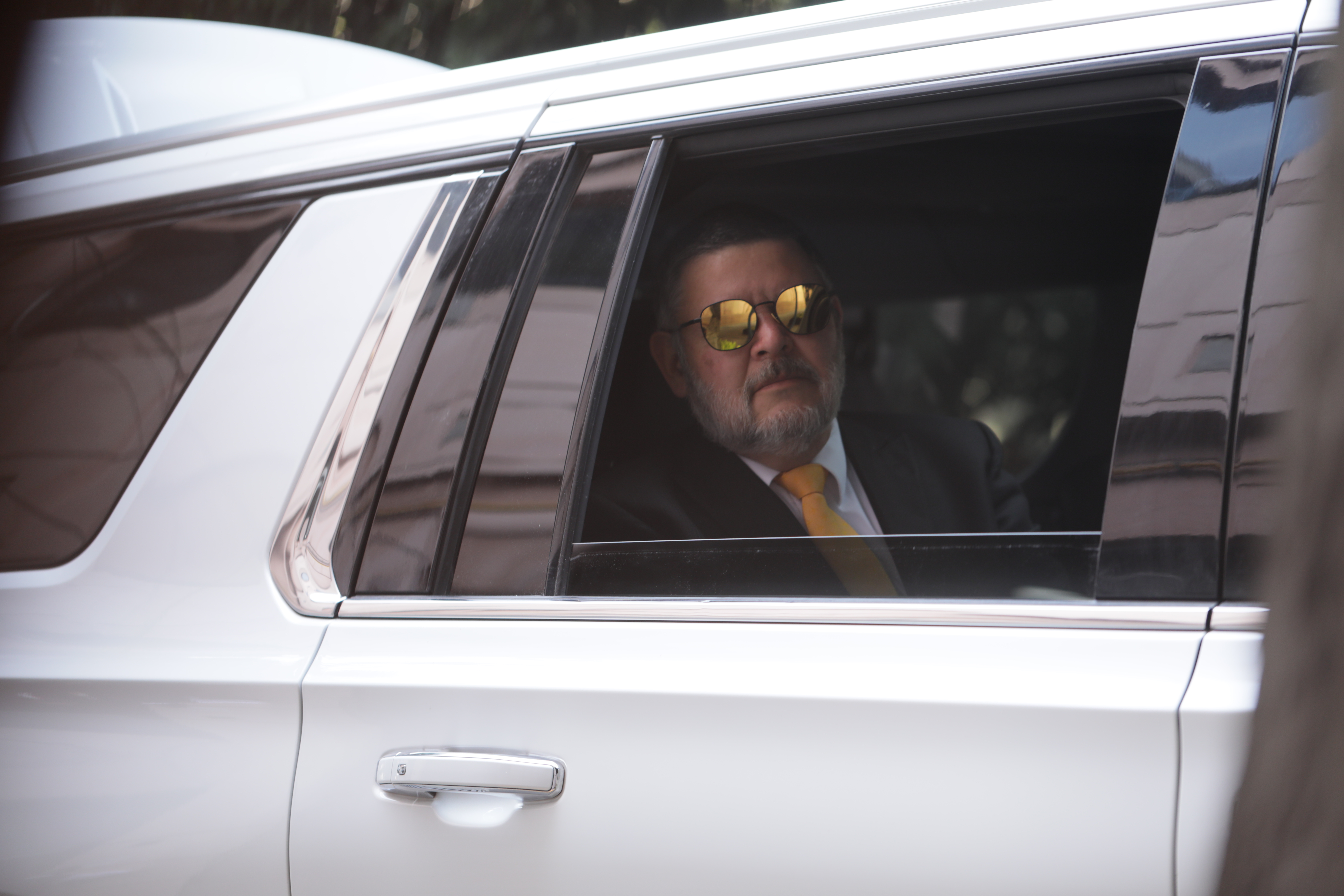 Businessman arriving at his destination in an Escalade van